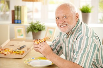 Canvas Print - Portrait of senior having pizza