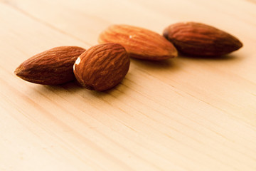 Wall Mural - Almonds isolated on wooden background