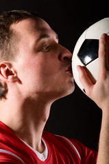 Wall Mural - soccer player is kissing the ball