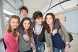 © goodluz - Group of classmates standing in school entrance hall
