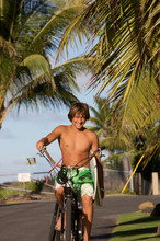 Surfer Riding A Beach Cruiser Bicycle With A Surfboard 2