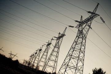 pylon and transmission power line in sunset