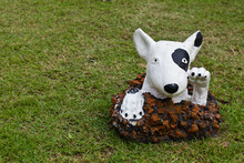 Statue Of A Dog Decorated On The Lawn