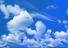White Clouds In The Dark Blue Sky As A Background
