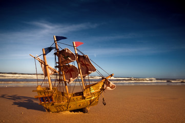 Wall Mural - Ship model on summer sunny beach