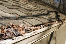 House Roof Gutter Filled With Leaves Autumn