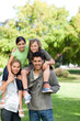 © WavebreakMediaMicro - Parents giving children a piggyback