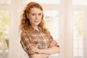 Wall Mural - Portrait of pretty young girl at home smiling