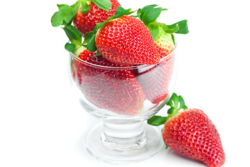 big juicy red ripe strawberries in a glass bowl isolated on whit