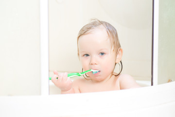 Wall Mural - baby brushing teeth sitting in shower