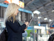 Business woman working at the Airport with mobile device