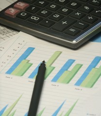 pen and calculator on the financial table