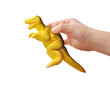 toy dinosaur in child’s hand on white background