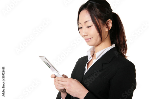 携帯電話を見るスーツの女性 Stock Photo Adobe Stock