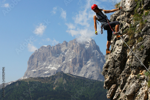 Fotografie, Obraz Young woman climbing in the Dolomits, Italy