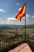 Spanish Flag Flying Over The Beautiful Town Of Ronda