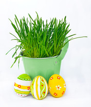 Easter Eggs Next To The Bucket With The Green Spring Grass