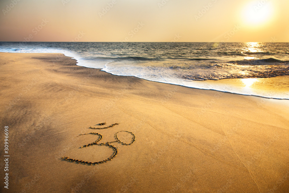 Om symbol on the beach - obrazy, fototapety, plakaty 
