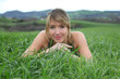 © goodluz - Beautiful woman laying down green field