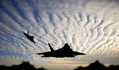 Poster - Silhouette of military attack aircraft against vibrant sunset sk