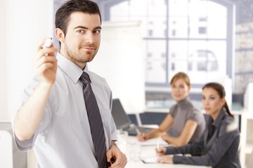 Wall Mural - Young businessman presenting smiling