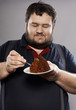 © dmitry_zubarev - funny fat guy eating chocolate cake