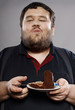 © dmitry_zubarev - funny fat guy eating chocolate cake