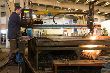 Cutting metal with CNC laser motion blurred.