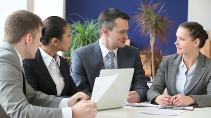 Canvas Print - Businesspeople sitting at the table and discussing