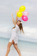 © Alena Yakusheva - young attractive woman with colorful balloons on sea background