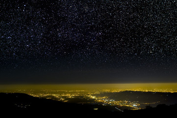 Wall Mural - the universe above city lights. the dark night sky.