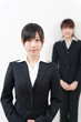© taka - two asian businesswomen standing