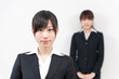 © taka - two asian businesswomen standing