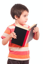 Little Boy Looks Aside While Reading Book