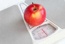 A Red Apple On The Weighs