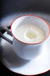 milk drops - milk drop into small cup with milk