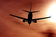 black silhouette of airplane agains the sun