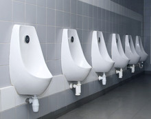 Modern Restroom Interior With Urinal Row