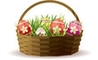 Easter basket with painted eggs in fresh grass