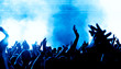 © DWP - concert crowd in front of bright blue stage lights