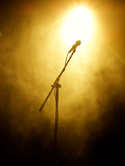 Poster - Microphone on stage with stage-lights in the background