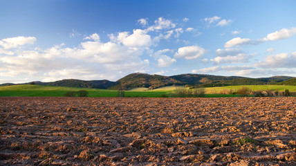 Poster - Rural view with plowed field in hills