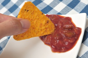 Wall Mural - Dipping tortilla chip into sauce