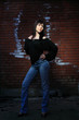 © Netfalls - fashion portrait of young woman with a brick wall