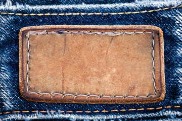 Blank leather jeans label sewed on a blue jeans