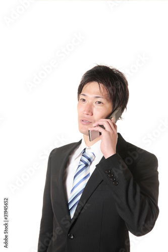 携帯電話で電話するスーツの男性 Stock Photo Adobe Stock