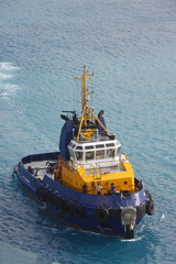 Poster - Yellow and Blue Tugboat in Aqua Water