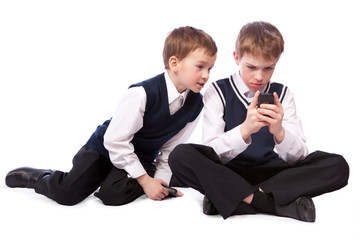 Wall Mural - Two schoolboys play on mobile phone