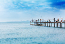 People Fishing On A Pier