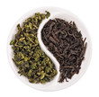 Green leaf tea versus black one in Yin Yang shaped plate, isolat